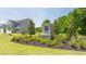 Landscaped community entrance featuring stone monument and green grass at 8603 Secretariat Dr, Lithonia, GA 30058