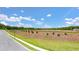 New landscaping with rows of young evergreen trees lining a newly paved sidewalk within a developing community at 8603 Secretariat Dr, Lithonia, GA 30058