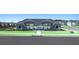 Exterior view of a community pool area with a covered seating area, black fencing, and well-kept lawn at 8603 Secretariat Dr, Lithonia, GA 30058