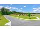 A newly paved street curves through green lawns and landscaping with mature hardwood trees in the background at 8603 Secretariat Dr, Lithonia, GA 30058