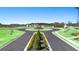 Scenic roundabout street view of a new construction home community with lush greenery and well-maintained landscaping at 8603 Secretariat Dr, Lithonia, GA 30058