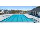 Community swimming pool featuring bright blue water, expansive deck, and stylish pool house in background at 8603 Secretariat Dr, Lithonia, GA 30058