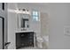 Well-lit bathroom featuring a black vanity, tiled wall, and a modern toilet for a fresh, clean aesthetic at 3286 Elwin Ragsdale Way, Acworth, GA 30102