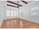 Bright bedroom featuring hardwood floors, beamed ceilings, and large windows for a warm, inviting space at 3286 Elwin Ragsdale Way, Acworth, GA 30102