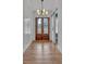 Open foyer with hardwood floors, elegant lighting, and detailed trim at 3286 Elwin Ragsdale Way, Acworth, GA 30102