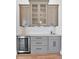 Stylish kitchenette featuring gray cabinets, a mini fridge, and a tiled backsplash at 3286 Elwin Ragsdale Way, Acworth, GA 30102