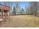 Lush backyard surrounded by trees and a partial view of the home's deck at 4030 Staghorn Ct, Douglasville, GA 30135