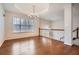 Elegant dining room with hardwood floors, chandelier, and large window, adjacent to a staircase at 4030 Staghorn Ct, Douglasville, GA 30135