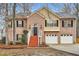 Inviting two-story brick home featuring a covered entrance, two-car garage, and well-kept landscaping at 4030 Staghorn Ct, Douglasville, GA 30135