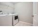 Laundry room features a washer, dryer, overhead shelving, and tile floors at 4030 Staghorn Ct, Douglasville, GA 30135