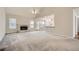 Bright and airy living space featuring a fireplace, large windows, and seamless transition to the kitchen at 4030 Staghorn Ct, Douglasville, GA 30135