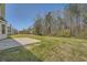 Large backyard includes a patio area, with treeline visible in background at 4157 Medlock Woods Dr, Snellville, GA 30039