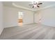 Bright bedroom showcasing neutral walls, carpet, a ceiling fan, and access to bathroom at 4157 Medlock Woods Dr, Snellville, GA 30039