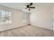 Bedroom features natural light, neutral carpet and walls, with a ceiling fan at 4157 Medlock Woods Dr, Snellville, GA 30039