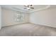 Spacious bedroom features a ceiling fan, window, and neutral carpet at 4157 Medlock Woods Dr, Snellville, GA 30039