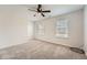 Neutral bedroom showcasing two windows and soft carpeting at 4157 Medlock Woods Dr, Snellville, GA 30039