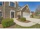 Close-up of a brick home with a two-car garage, showcasing a well-maintained lawn and trimmed shrubs at 4157 Medlock Woods Dr, Snellville, GA 30039