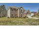 Side view of a two-story brick home featuring red shutters, manicured lawn, and an attached garage at 4157 Medlock Woods Dr, Snellville, GA 30039
