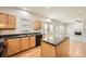 Open kitchen featuring an island, light wood cabinetry, and stainless steel appliances with hardwood flooring at 4157 Medlock Woods Dr, Snellville, GA 30039