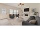 Cozy living room with fireplace, ceiling fan, and plenty of natural light at 4157 Medlock Woods Dr, Snellville, GA 30039