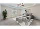 Elegant primary bedroom with tray ceiling, neutral decor, and comfortable furnishings at 4157 Medlock Woods Dr, Snellville, GA 30039