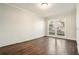 Bedroom featuring hardwood floors, a large window, and painted brick walls at 4981 Crowe Se Dr, Smyrna, GA 30082