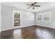 Bright bedroom with hardwood flooring, two windows, and a ceiling fan at 4981 Crowe Se Dr, Smyrna, GA 30082