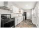 Well-appointed kitchen featuring stainless steel appliances, granite counters, and white cabinetry at 4981 Crowe Se Dr, Smyrna, GA 30082