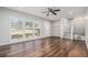 Bright living room featuring hardwood floors, natural light, ceiling fan, and easy access to the upstairs and basement at 4981 Crowe Se Dr, Smyrna, GA 30082