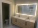 Bathroom featuring a light wood vanity, modern mirror, and shower at 1285 Mcclure Nw Ave, Atlanta, GA 30314