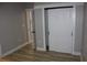 Bedroom showcasing a sliding closet door and light wood-look flooring at 1285 Mcclure Nw Ave, Atlanta, GA 30314