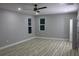 A spacious bedroom with light gray walls, stylish ceiling fan, and elegant light-colored wood flooring at 1285 Mcclure Nw Ave, Atlanta, GA 30314