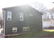 Side view of home's dark green siding with white trim windows, and green lawn at 1285 Mcclure Nw Ave, Atlanta, GA 30314