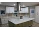 The kitchen boasts an eat-in island, stainless appliances, stylish pendant lights, and ample cabinet space at 1285 Mcclure Nw Ave, Atlanta, GA 30314