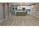 Spacious open-concept kitchen features a large island, stainless steel appliances, and bright white cabinetry at 1285 Mcclure Nw Ave, Atlanta, GA 30314