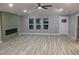 Spacious living room with modern fireplace, wood-look floors, and natural light at 1285 Mcclure Nw Ave, Atlanta, GA 30314