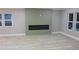 The living room features stylish flooring, an electric fireplace, and large windows overlooking the backyard at 1285 Mcclure Nw Ave, Atlanta, GA 30314