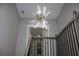 Staircase with modern chandelier and wood and metal railing at 1285 Mcclure Nw Ave, Atlanta, GA 30314
