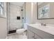 Modern bathroom featuring marble-look tiles, a tiled walk-in shower, and sleek vanity at 1669 Glen Arm Dr, Lithonia, GA 30058