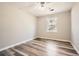 Bright bedroom with large window, ceiling fan, and durable gray vinyl flooring at 1669 Glen Arm Dr, Lithonia, GA 30058