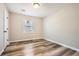 Cozy bedroom features a large window, closet, and durable gray vinyl flooring at 1669 Glen Arm Dr, Lithonia, GA 30058