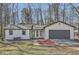 Charming single-story home with a gray garage door and a well-maintained front yard at 1669 Glen Arm Dr, Lithonia, GA 30058