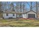Inviting single-story home featuring a well-manicured lawn and a gray garage door at 1669 Glen Arm Dr, Lithonia, GA 30058