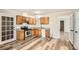Charming kitchen features wood cabinets, stainless steel appliances, and durable gray vinyl flooring at 1669 Glen Arm Dr, Lithonia, GA 30058
