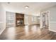 Spacious living room featuring hardwood floors and a classic brick fireplace at 1669 Glen Arm Dr, Lithonia, GA 30058