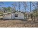 Rear exterior showing the siding, covered porch and yard at 1669 Glen Arm Dr, Lithonia, GA 30058