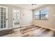 Bright room featuring durable gray vinyl flooring, french doors and a large window with natural light at 1669 Glen Arm Dr, Lithonia, GA 30058