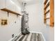 Utility room features gray wood-look flooring and a standard hot water heater at 1669 Glen Arm Dr, Lithonia, GA 30058