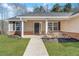 Inviting home entrance with a concrete walkway, tidy landscaping, and brick accents at 217 Lamb Rd, Moreland, GA 30259