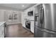 Kitchen boasts stainless appliances, white countertops, and stylish wood-look flooring at 217 Lamb Rd, Moreland, GA 30259